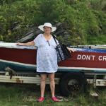 Evelyn Tina Bass standing next to a speed boat