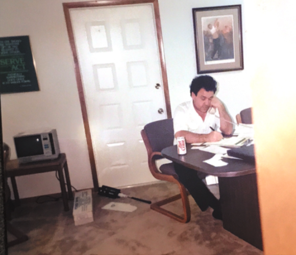 Eric Dawson on a phone at a desk