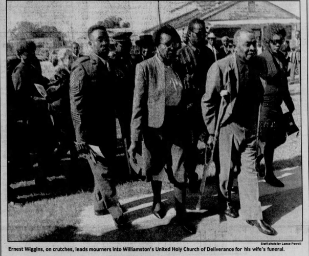 Earnest Wiggins walking on crutches at his wife Jean’s funeral