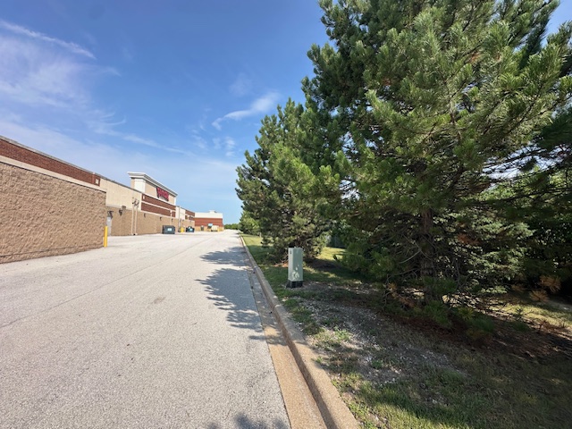 Service road behind the former site of the Lane Bryant store as of August and November 2025 showing its close proximity to Interstate 80